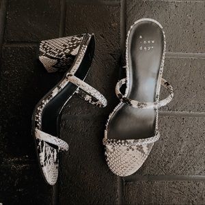 snake print heeled pumps